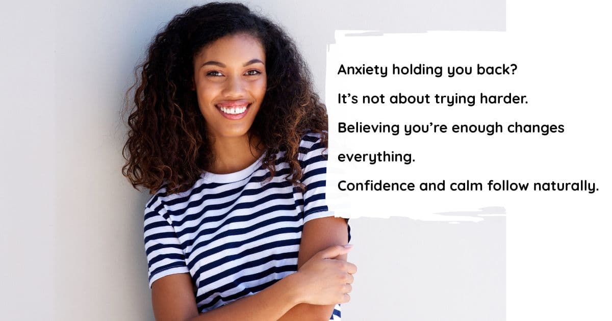 Pretty woman smiling at the camera with hands folded, looking accomplished and confident, representing overcoming anxiety and building self-worth