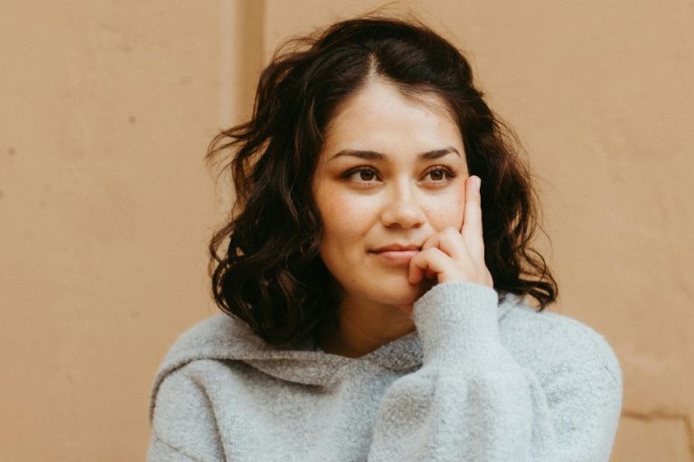 A woman with a gentle smile and relaxed posture, representing the confidence, self‑trust, and emotional ease that return after releasing unfair guilt.