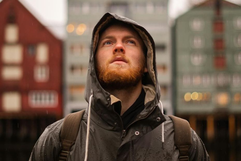 A person standing outside in a quiet, steady posture, capturing the sense of pausing when the mind feels overwhelmed.