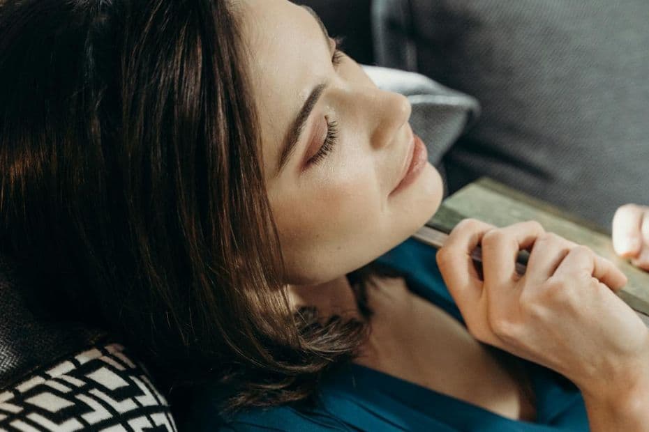Person reclining in soft light, appearing thoughtful and composed symbolising inner strength and self‑criticism