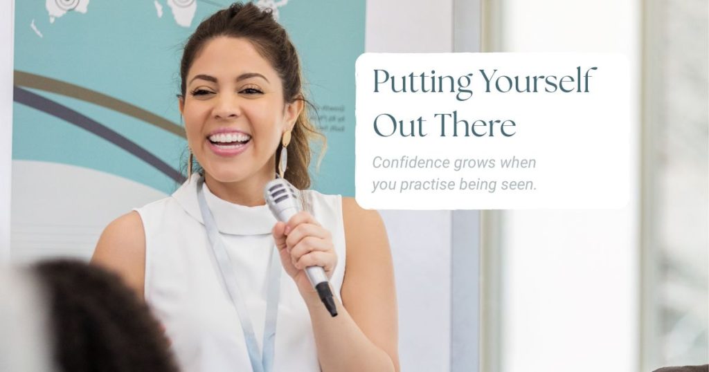 Smiling woman speaking confidently into a microphone during a relaxed presentation.