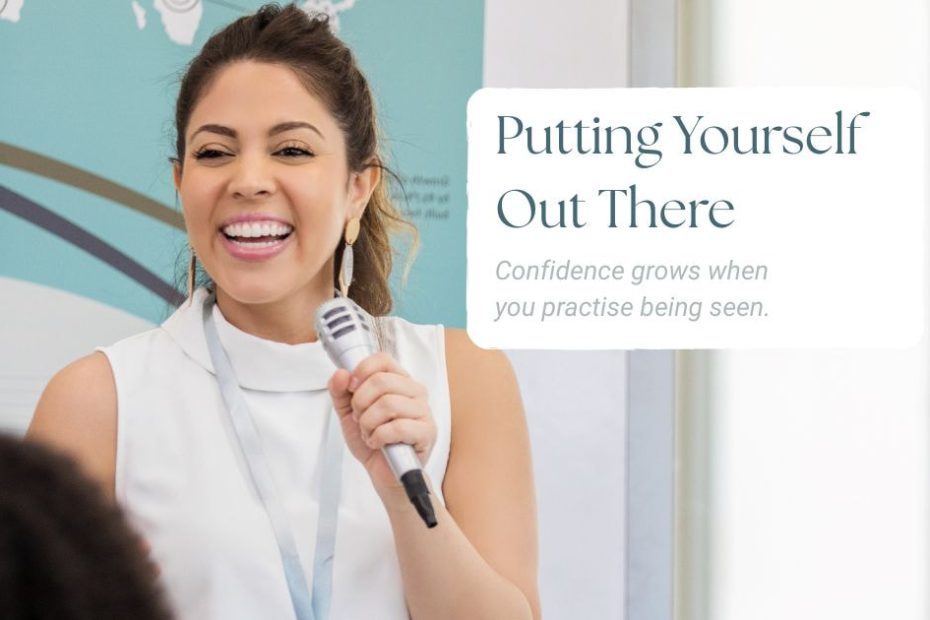 Smiling woman speaking confidently into a microphone during a relaxed presentation.